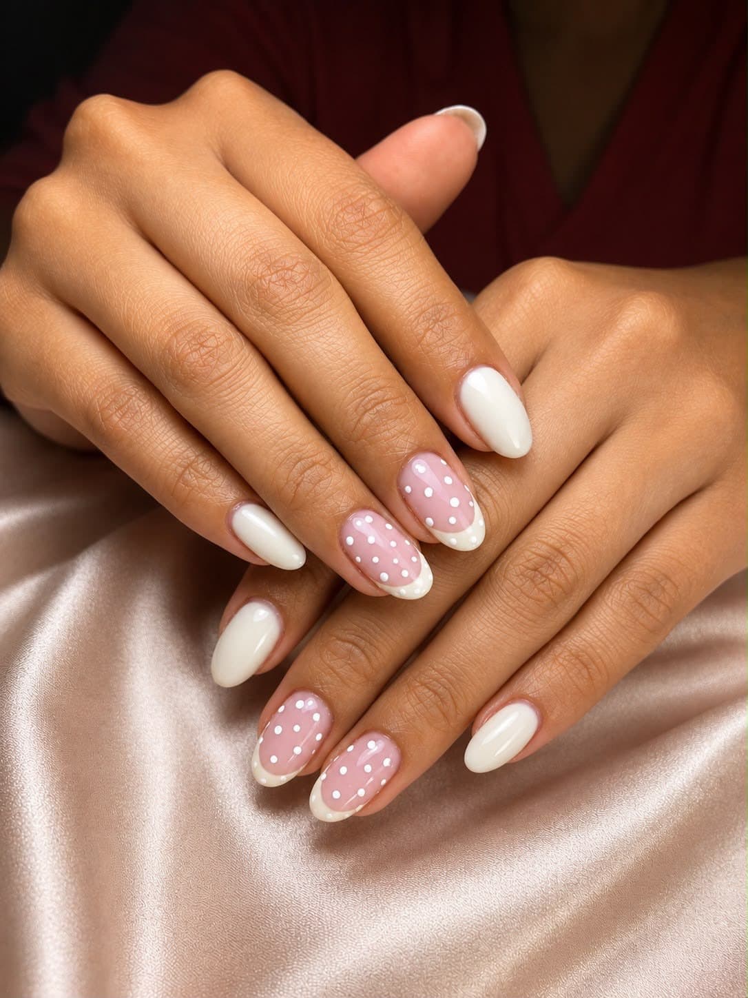 White almond manicure with hand-painted polka dots